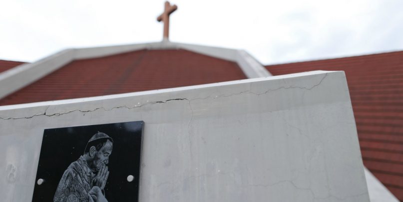 A plaque with the image of Bishop Gustavo Zanchetta is seen outside the cathedral in Oran, Argentina, on Wednesday, Jan. 16, 2019. Earlier in January, the Vatican confirmed that the new bishop of Oran had opened a canonical investigation into Zanchetta for alleged sexual abuses. (AP Photo/Natacha Pisarenko)