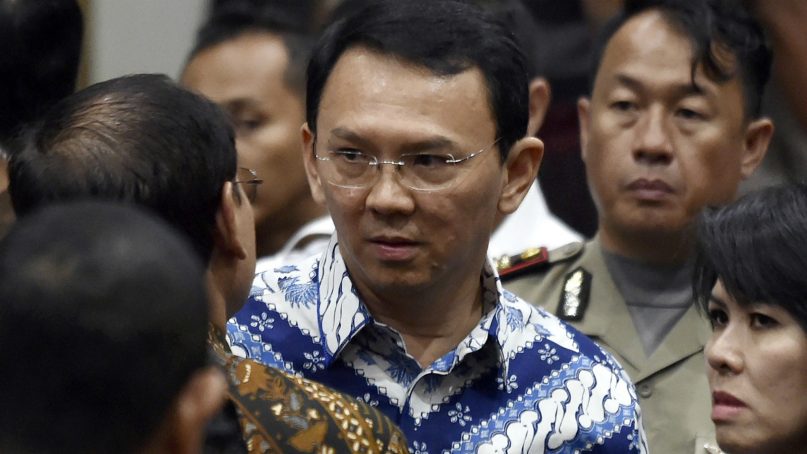 In this May 9, 2017, file photo, then Jakarta Governor Basuki “Ahok” Tjahaja Purnama, center, talks to his lawyers after his sentencing hearing at a court in Jakarta, Indonesia, Tuesday, May 9, 2017. The polarizing Christian politician whose campaign comments ignited protests that were the largest in Muslim-majority Indonesia in years was freed Thursday, Jan. 24, 2019 after serving nearly two years in prison for blasphemy. (Bay Ismoyo/Pool Photo via AP, File)