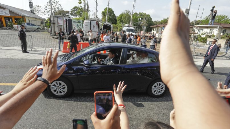 People wave as Pope Francis rides past in Panama City, Thursday, Jan. 24, 2019. Francis opens his first full day Thursday with a visit to the presidential palace and rounds out the day with his evening welcome to tens of thousands of young Catholics gathered for World Youth Day, the church's big youth rally. (AP Photo/Tito Herrera)