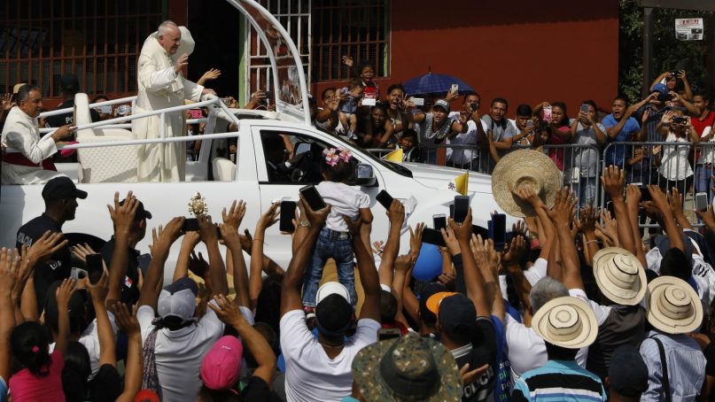 Local residents line the roadside to greet Pope Francis as he rides past in his Popemobile en route to Las Garzas de Pacora detention center for minors, in Panama, Friday, Jan. 25, 2019. Francis will celebrate a special penitential Mass for Panama's juvenile delinquents inside the Central American country's main youth lockup. (AP Photo/Rebecca Blackwell)