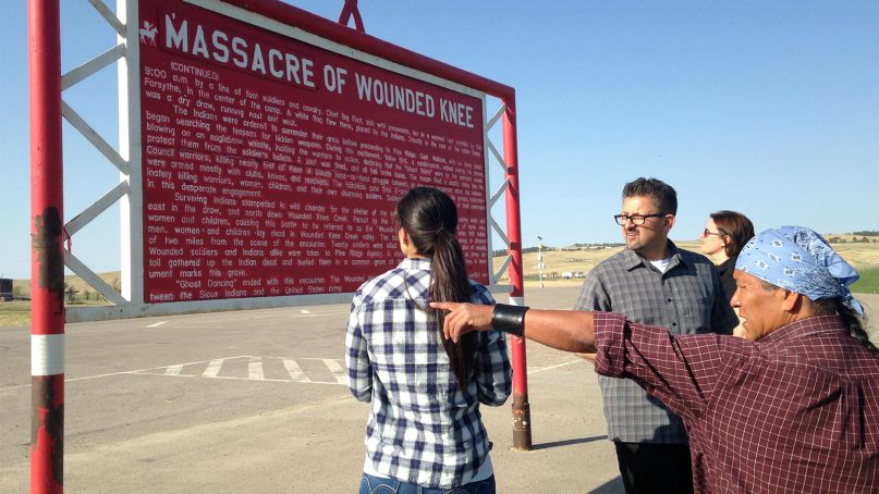 Native American cartoonist Ricardo Cate', far right, and Chicano cartoonist Lalo Alcaraz, third right, visit Wounded Knee Memorial at Wounded Knee, S.D., on the Pine Ridge Indian Reservation on May 1, 2015. The nightclub attack in Orlando was initially described by some news organizations, including The Associated Press, as the deadliest mass shooting in U.S. history. In truth, America has seen even bigger massacres, some involving hundreds of men, women and children, like the one at Wounded Knee in 1890 against the Lakota. (AP Photo/Russell Contreras)