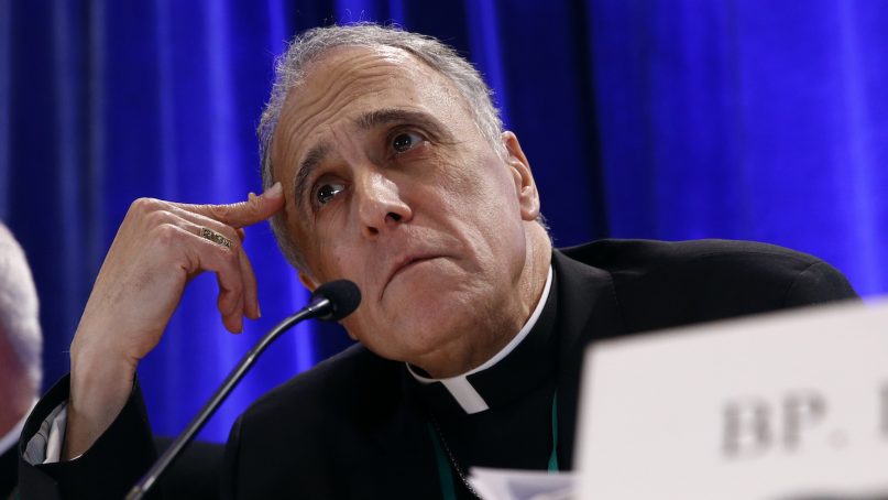 FILE - In this Nov. 12, 2018, file photo, Cardinal Daniel DiNardo of the Archdiocese of Galveston-Houston, president of the United States Conference of Catholic Bishops, listens to a reporter's question during a news conference during the USCCB's annual fall meeting in Baltimore. Prosecutors investigating a sexual abuse case against a Houston-area priest are executing a search warrant at the offices of the local archdiocese, led by DiNardo, the cardinal leading the Catholic Church’s response in the U.S. to sexual misconduct. Investigators from the Montgomery County District Attorney’s Office were at the offices Wednesday, Nov. 28, 2018, of the Archdiocese of Galveston-Houston. (AP Photo/Patrick Semansky, File)