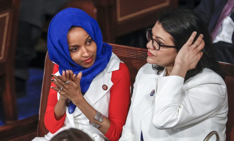 In this Feb. 5, 2019, photo, Rep. Ilhan Omar, D-Minn., left, joined at right by Rep. Rashida Tlaib, D-Mich., listens to President Trump's State of the Union speech at the Capitol in Washington. (AP Photo/J. Scott Applewhite)