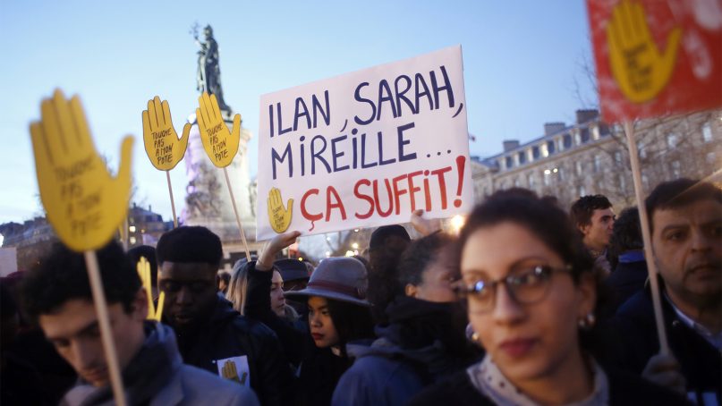 People gather at Republique square to protest against anti-Semitism, in Paris, France, on Feb. 19, 2019. The banner refers to French jews assassinated recently with the words reading : “It is enough.” In Paris and dozens of other French cities, ordinary citizens and officials across the political spectrum geared up Tuesday to march and rally against anti-Semitism, following a series of anti-Semitic acts that shocked the nation. (AP Photo/Thibault Camus)