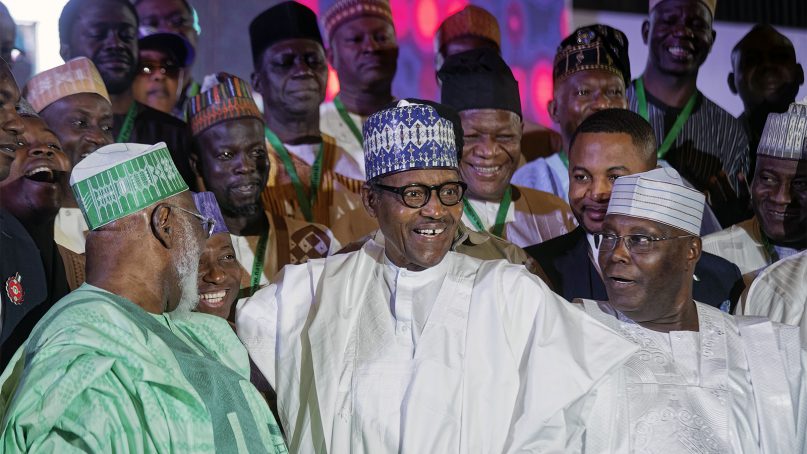 Incumbent President Muhammadu Buhari, center, and opposition presidential candidate Atiku Abubakar, right, stand for a group photo with other candidates after signing an electoral peace accord at a conference center in Abuja, Nigeria, on Feb. 13, 2019. Nigeria is due to hold general elections on Saturday, Feb. 16, 2019. (AP Photo/Ben Curtis)