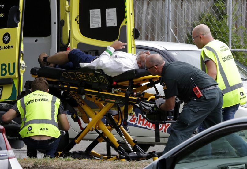 Ambulance staff take a man from outside a mosque in central Christchurch, New Zealand, Friday, March 15, 2019.  Multiple people were killed in mass shootings at two mosques full of worshippers attending Friday prayers on what the prime minister called 