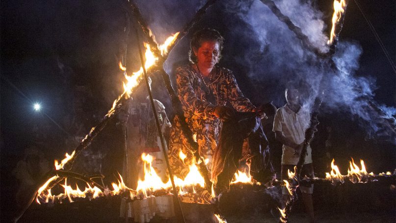A woman burns a piece of clothing in a flaming pentagram during a black mass on March 2, 2019, in Catemaco, Mexico. The action symbolized the closing of a cycle by destroying the garment.  RNS photo by Irving Cabrera Torres