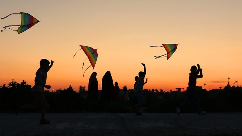 Children launch kites during Nowruz celebrations as the sun sets in Baghdad, Iraq, on March 21, 2019. Nowruz, the Farsi-language word for 