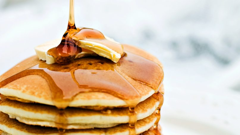 Pancakes are drizzled with syrup. Photo by Michael Stern/Creative Commons