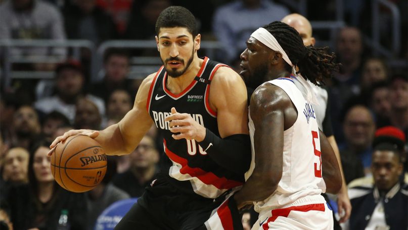 Portland Trail Blazers center Enes Kanter, left, drives against Los Angeles Clippers' defender Montrezl Harrell during an NBA basketball game March 12, 2019, in Los Angeles. (AP Photo/Ringo H.W. Chiu)