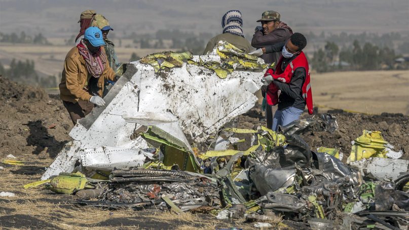Recovery workers collect debris at the scene of an Ethiopian Airlines flight crash near Bishoftu, or Debre Zeit, south of Addis Ababa,  Ethiopia, on March 11, 2019. A spokesman said Ethiopian Airlines has grounded all its Boeing 737 Max 8 aircraft as a safety precaution, after the crash of one of its planes in which 157 people were killed. (AP Photo/Mulugeta Ayene)