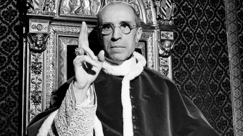 In this file photo dated September 1945, Pope Pius XII, wearing the ring of St. Peter, raises his right hand in a papal blessing at the Vatican. (AP Photo, File)