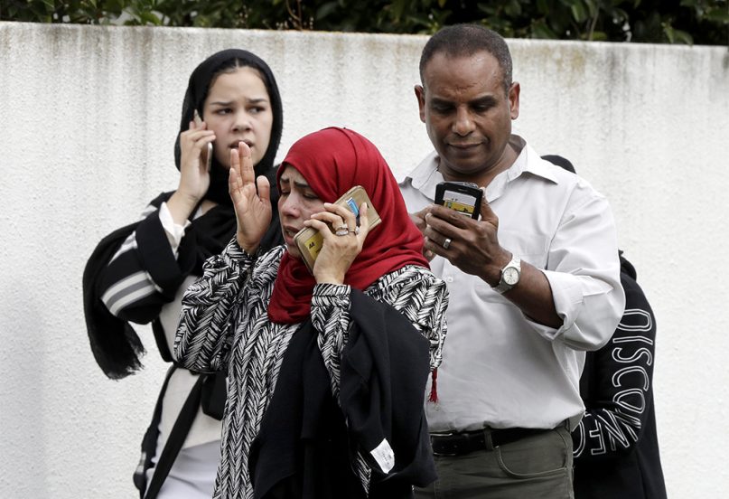 People wait outside a mosque in central Christchurch, New Zealand, on March 15, 2019. Many people were killed in a mass shooting at two mosques in the New Zealand city of Christchurch on Friday, witnesses said. Police have not yet described the scale of the shooting but urged people in central Christchurch to stay indoors. (AP Photo/Mark Baker)