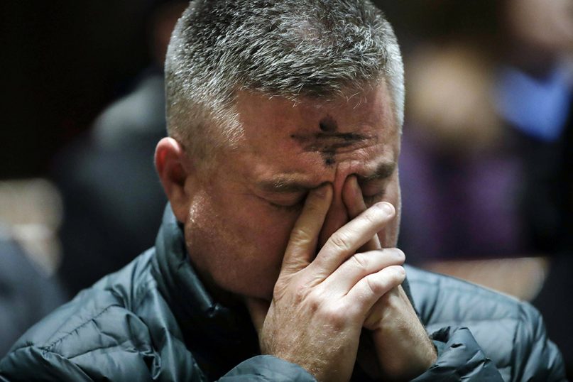 A worshipper prays during an Ash Wednesday Mass at the Cathedral Basilica of Sts. Peter and Paul in Philadelphia, on March 6, 2019. (AP Photo/Matt Rourke)