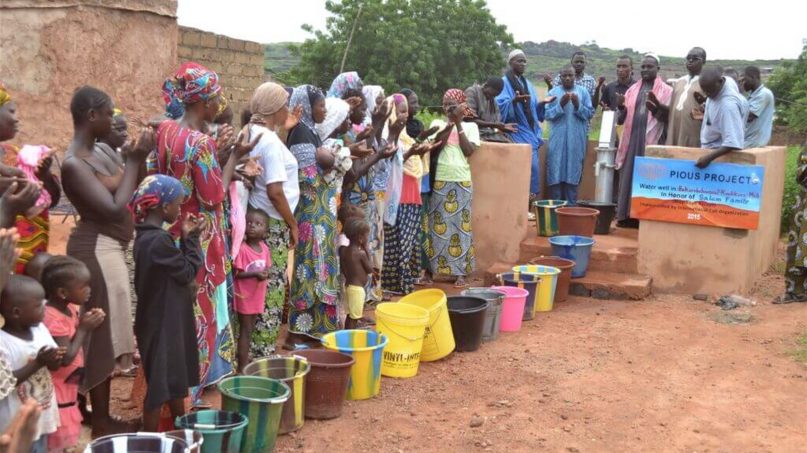 Locals pray for donors at the grand opening of a water well in Mali's Al Najwa villages. The well was created by Pious Projects. Photo courtesy of Pious Projects