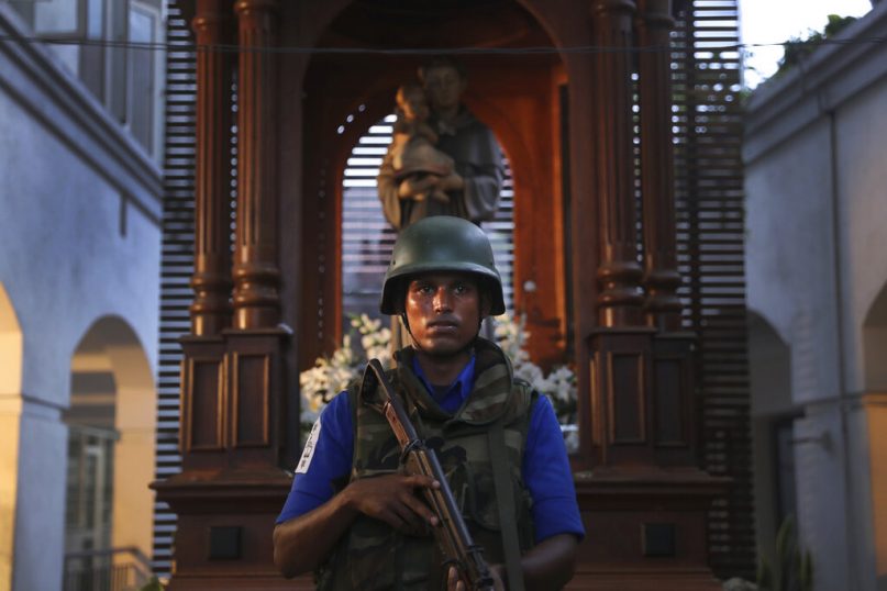 A Sri Lankan soldier stands guard at the damaged St. Anthony's Church or Shrine in Colombo, Sri Lanka, on April 26, 2019. Priests have allowed journalists inside the church for the first time since it was targeted in a series of Islamic State-claimed suicide bombings that killed over 250 people. Broken glass littered the sanctuary's damaged pews and blood stained the floor. Shoes left by panicked worshippers remained in the darkened church, and broken bottles of holy water lay on the floor. (AP Photo/Manish Swarup)