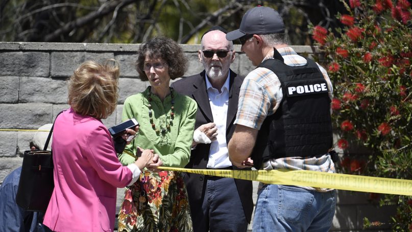 Synagogue members talk to a San Diego County Sheriff's deputy outside of the Chabad of Poway Synagogue on April 27, 2019, in Poway, Calif. Several people were injured in a shooting at the synagogue. (AP Photo/Denis Poroy)
