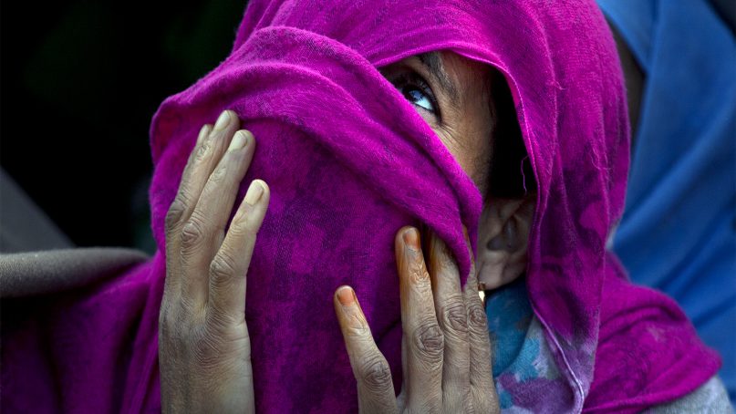 A Kashmiri Muslim woman with her face covered prays as the head cleric displays a relic at the Hazratbal shrine on the occasion of Mehraj-u-Alam, believed to mark the ascension of Prophet Muhammad to heaven, in Srinagar, Indian controlled Kashmir,  on April 4, 2019. Thousands of Kashmiri Muslims gathered at the Hazratbal shrine, which houses a relic believed to contain hair from the beard of Islam's Prophet Muhammad. (AP Photo/Dar Yasin)
