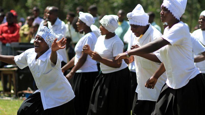 Women dance and sing during an open-air worship service in Uganda. Photo by Adam Cohn/Creative Commons