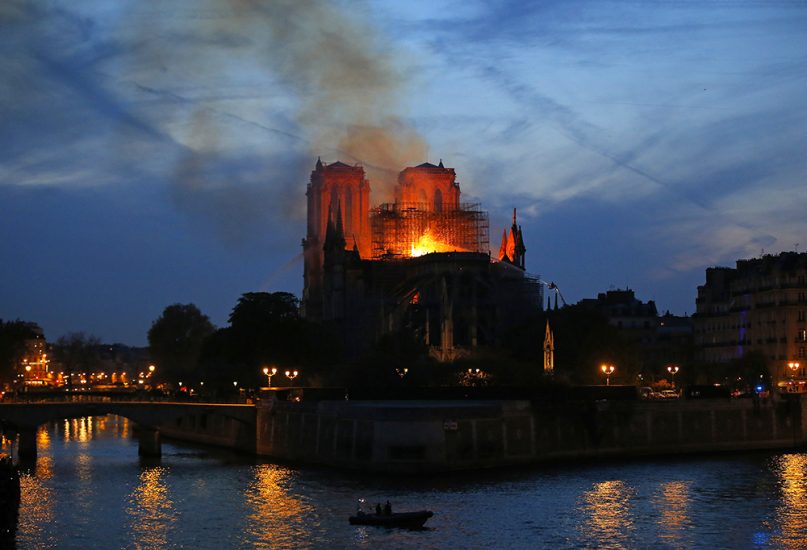Firefighters tackle the blaze as flames and smoke rise from Notre Dame Cathedral in Paris on April 15, 2019. (AP Photo/Michel Euler)