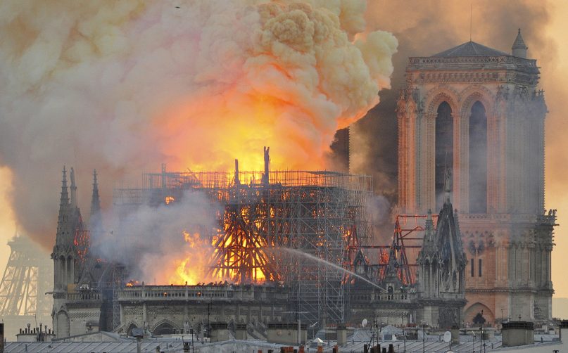 Flames and smoke rise from the blaze after the spire toppled on Notre Dame Cathedral in Paris, on April 15, 2019. An inferno that raged through Notre Dame Cathedral for more than 12 hours destroyed its spire and its roof but spared its twin medieval bell towers, and a frantic rescue effort saved the monument's 