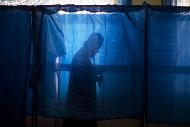 Baryshevsky Victor, Bishop of the Kiev Monastery of the Caves, holds his ballot at a polling station, during the presidential elections in Kiev, Ukraine, on March. 31, 2019. (AP Photo/Emilio Morenatti)