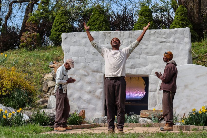 Andre Roberson, center, portrays a resurrected Jesus in a rehearsal for
an Easter sunrise service on April 17, 2019 at King Memorial Park in Baltimore County, Md. Angels are portrayed by Lou “Lufty” Mandhiry, left, and Stacey Maith, right. RNS photo by Adelle M. Banks