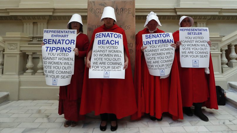Female demonstrators, dressed as characters from 