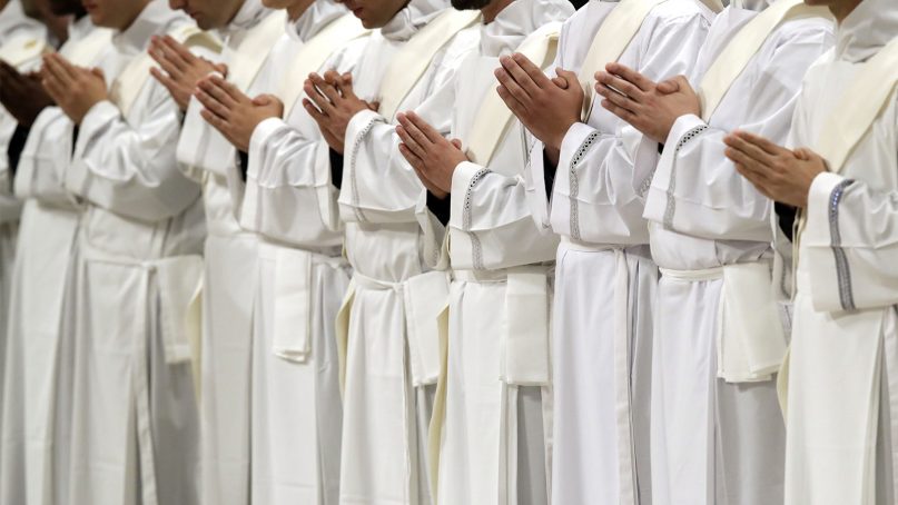 Newly ordained priests pray during a ceremony led by Pope Francis in St. Peter’s Basilica at the Vatican on May 12, 2019. (AP Photo/Alessandra Tarantino)
