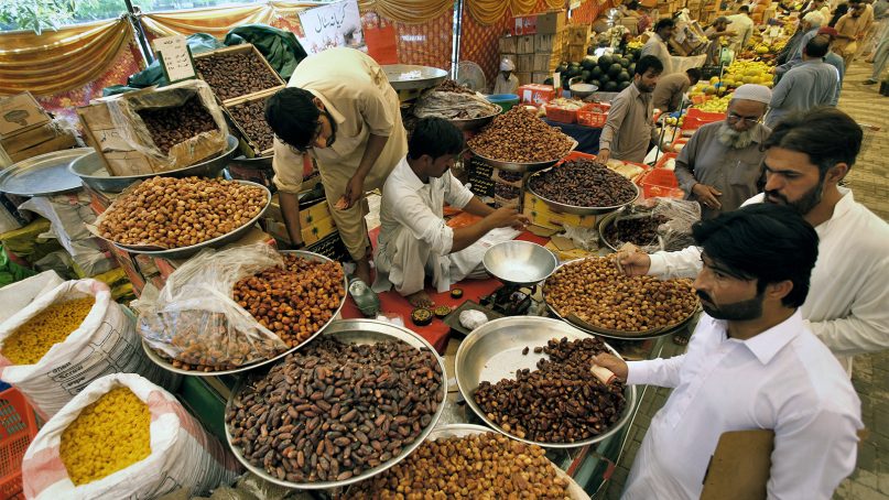 Pakistani Muslims buy dates, a favorite food for iftar, the meal to break their fast, from a government-run bazaar specially set up for the fasting month of Ramadan, in Rawalpindi, Pakistan, on May 7, 2019. Muslims around the world are observing Ramadan, the holiest month of the Islamic calendar. (AP Photo/Anjum Naveed)