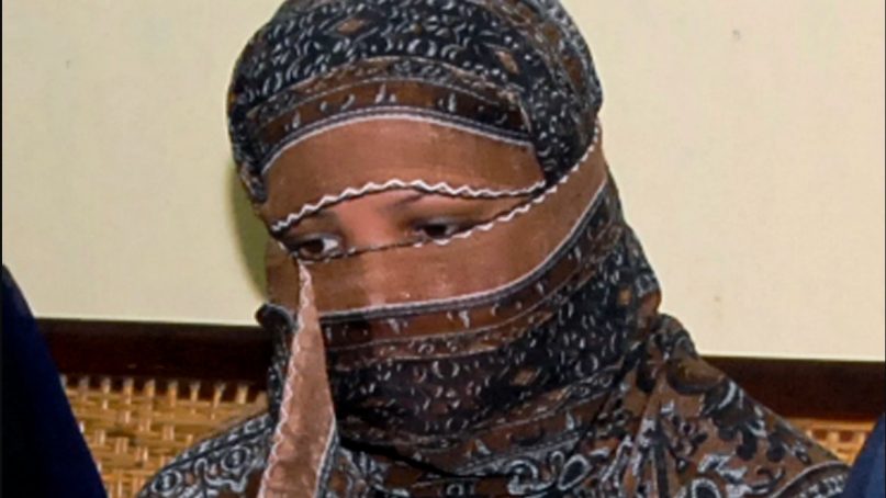 In this Nov. 20, 2010, file photo, Asia Bibi, a Pakistani Christian woman, listens to officials at a prison in Sheikhupura near Lahore, Pakistan. Pakistani media say Bibi, a Christian woman acquitted of blasphemy after spending eight years on death row, has left Pakistan for Canada to be reunited with her daughters. Wilson Chawdhry of the British Pakistani Christian Association told The Associated Press on May 8, 2019, he received a telephone text message from a British diplomat stating simply that “Aasia is out.” (AP Photo, File)