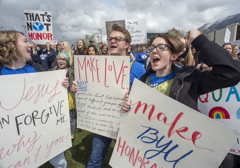 Hundreds of students gather on the campus of Brigham Young University for a rally to oppose how the school's Honor Code Office investigates and disciplines students, on April 12, 2019, in Provo, Utah. A strict set of rules at Mormon-owned Brigham Young University banning things commonplace at many campuses, such as drinking, premarital sex, beards and piercings, is under new scrutiny — this time from students who want their university to be more compassionate with the punishments for violators. (Rick Egan/The Salt Lake Tribune via AP)