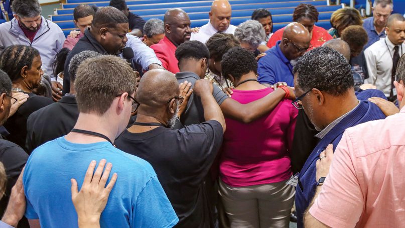 Participants of the Dallas Racial Unity Leadership Summit pray together. Photo courtesy of ACU's Carl Spain Center