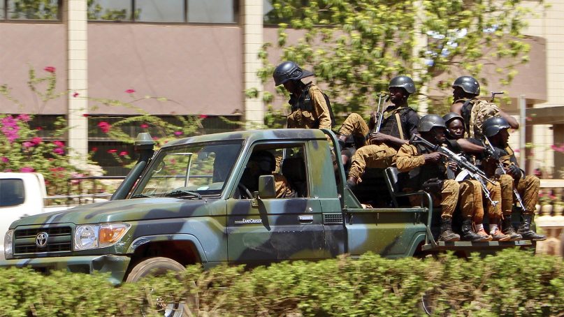 Military troops ride in a vehicle in central Ouagadougou, Burkina Faso, following an Islamic extremist attack on March 2, 2018. (AP Photo/ Ludivine Laniepce)