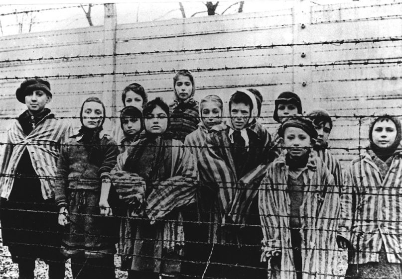 A picture taken just after the liberation by the Soviet army in January, 1945, shows a group of children wearing concentration camp uniforms behind barbed wire fencing in the Oswiecim (Auschwitz) Nazi concentration camp. Pasa Balter, fourth from left, who is now known as Paula Lebovics, is 61 and living in Encino, Calif., a survivor who bears the heartbreak of having lost most of her family. Germany on Monday, Jan. 27,1997, observes the country's Holocaust memorial day in memory of victims of the Nazis, which was declared a special day of reflection by President Roman Herzog last year. (AP Photo/CAF pap)