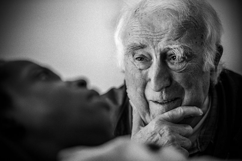 Jean Vanier visits Sebastien, a young man whose injuries in a car accident left him with profound cognitive and physical disabilities, at the L'Arche care home in Trosly-Breuil, France, in 2015. Photo courtesy of Summer in the Forest/R2W Films