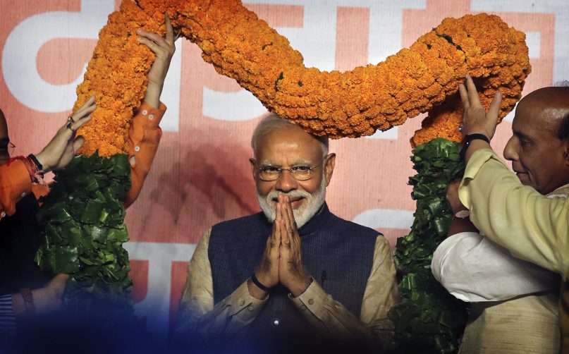 Indian Prime Minister Narendra Modi receives a giant floral garland from party leaders at their headquarters in New Delhi, India, on May 23, 2019, after winning the elections (AP Photo/Manish Swarup)