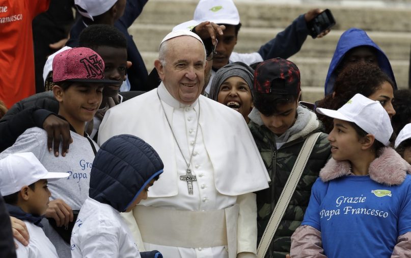 Pope Francis meets a group of migrants recently arrived from Libya, wearing shirts with writing reading “Thank you Pope Francis,” at the end of his weekly general audience in St. Peter’s Square, at the Vatican, May 15, 2019. (AP Photo/Andrew Medichini)