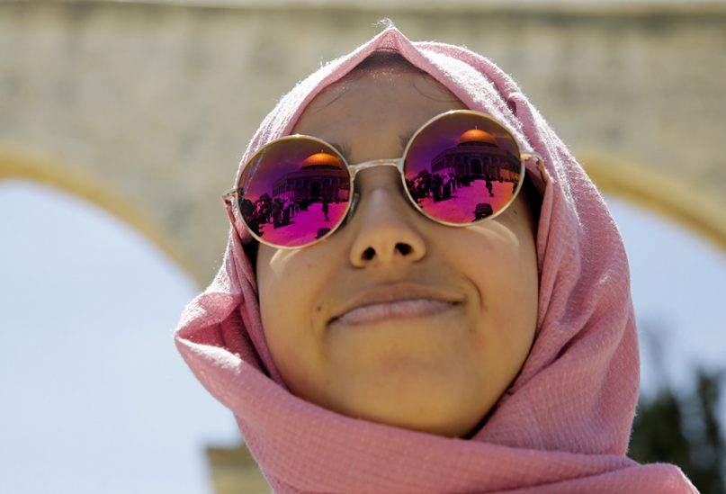 The Dome of the Rock shrine reflects in a pilgrim’s sunglasses during the first Ramadan Friday prayers, in Jerusalem, on May 10, 2019. (AP Photo/Mahmoud Illean)