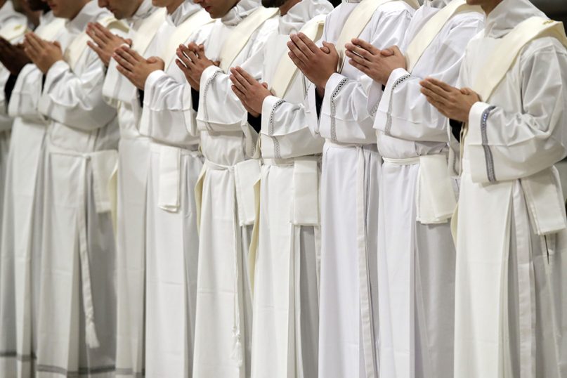 Newly ordained priests pray during a ceremony led by Pope Francis in St. Peter's Basilica at the Vatican on May 12, 2019. (AP Photo/Alessandra Tarantino)