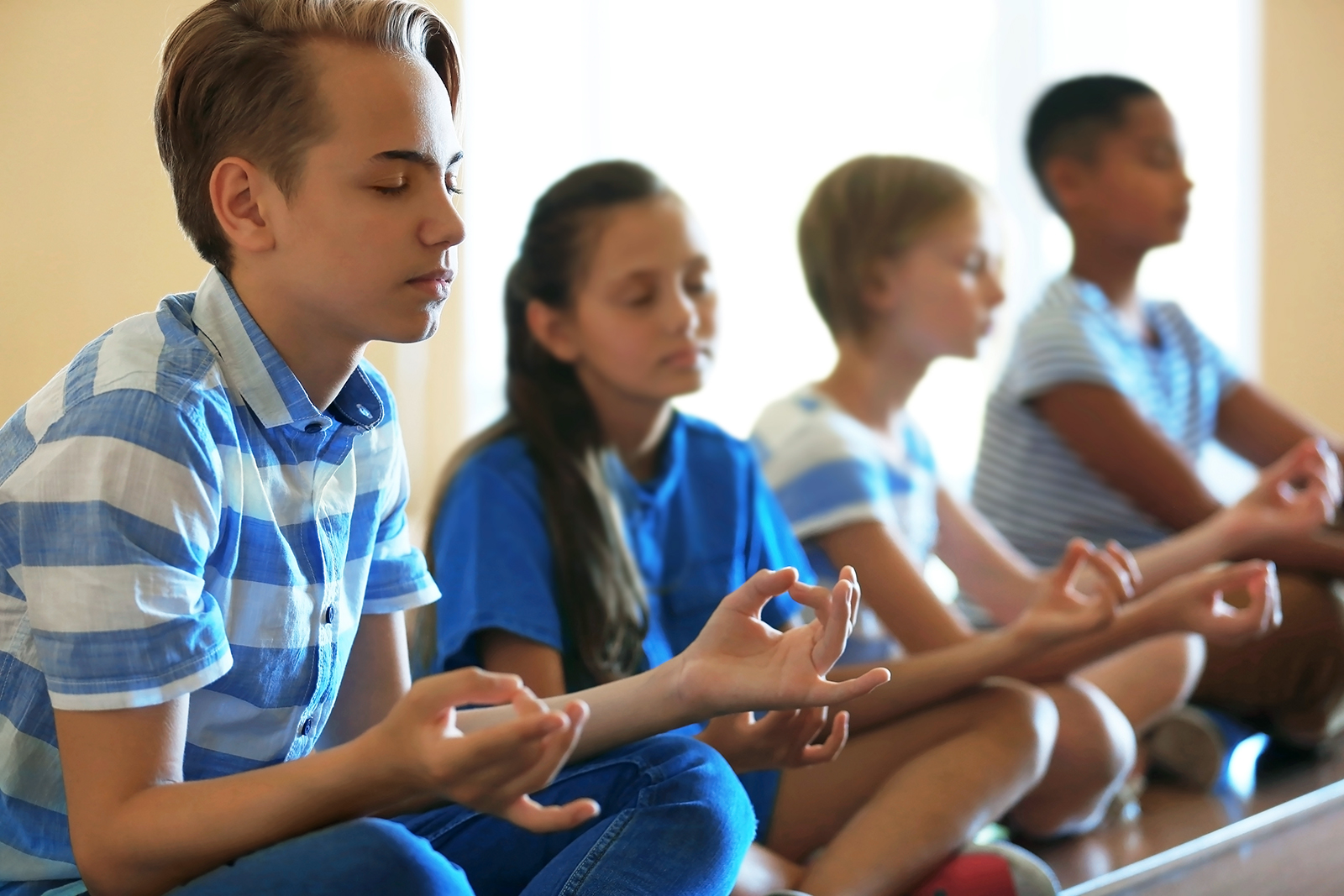 Yoga classes are becoming more prevalent in America’s schools. Africa Studio via www.shutterstock.com