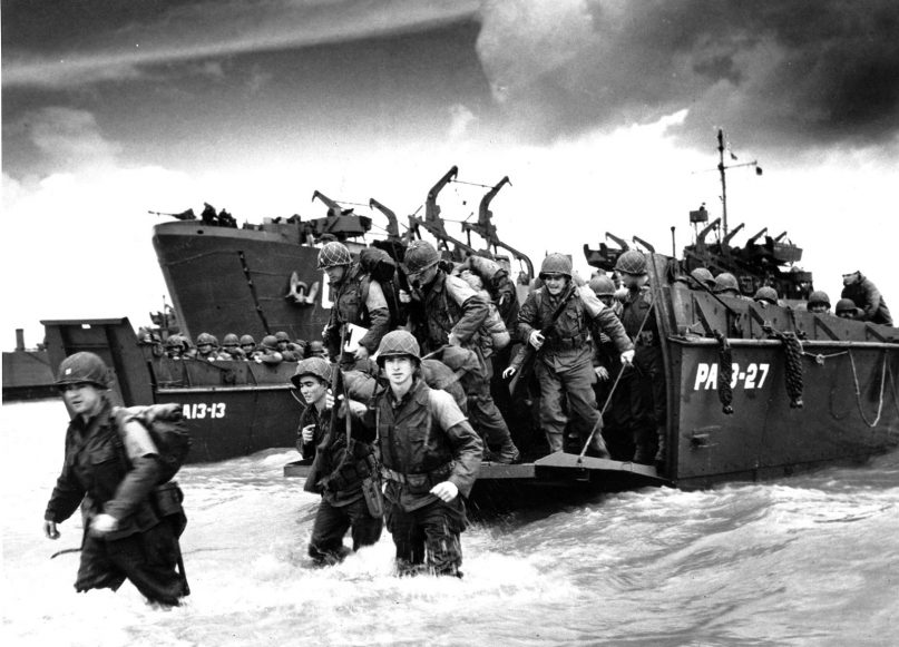 American reinforcements arrive on the beaches of Normandy from a Coast Guard landing barge into the surf on the French coast on June 23, 1944, during World War II.  (AP Photo/U.S. COAST GUARD)