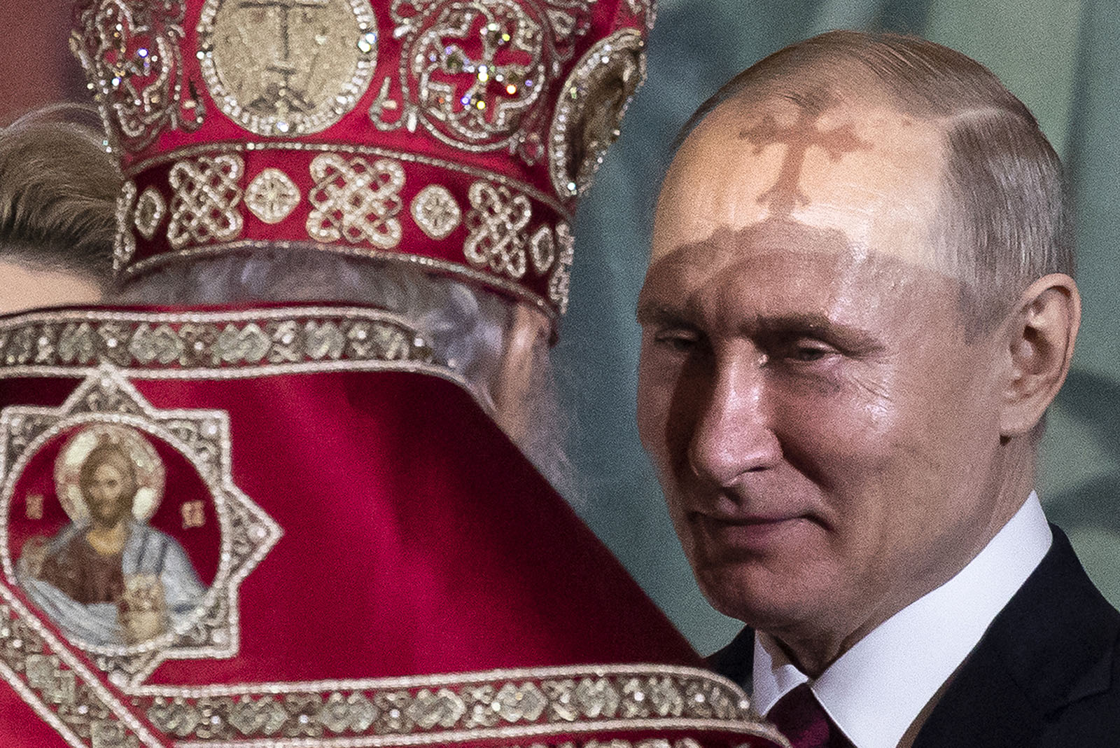 Russian Orthodox Patriarch Kirill, left, talks to President Vladimir Putin, right, during the Easter service in the Christ the Savior Cathedral in Moscow, Russia, Sunday, April 28, 2019. Orthodox Christians around the world celebrated Easter on Sunday, April 28. (AP Photo/Alexander Zemlianichenko)