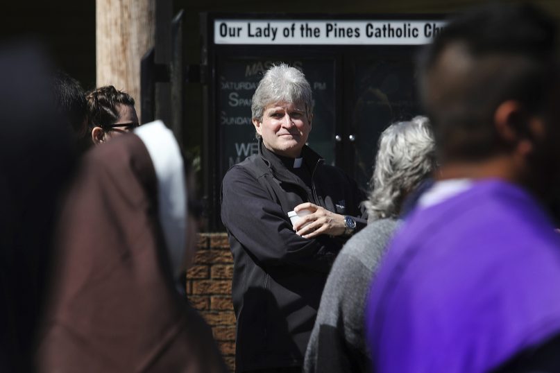 Monsignor Frank Rossi stands outside Our Lady of the Pines Catholic Church in Woodville, Texas, on April 14, 2019. (AP Photo/Wong Maye-E)