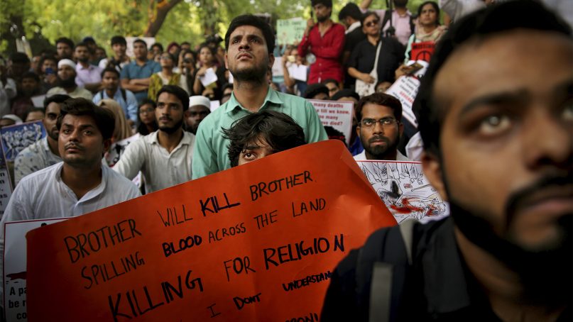 Indians hold placards condemning a recent mob lynching of Muslim youth Tabrez Ansari in Jharkhand state as they listen to a speaker during a protest in New Delhi, India, on June 26, 2019. Since Prime Minister Narendra Modi took the helm of the Indian government, Hindu mobs have lynched dozens of people, mainly Muslims and lower-caste Dalits. (AP Photo/Altaf Qadri)