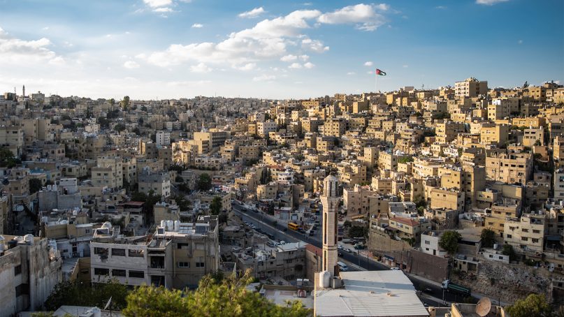 A Jordanian flag flies over the Amman, Jordan, skyline. Photo courtesy of Creative Commons