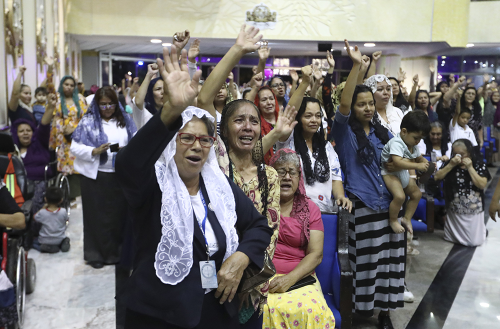 Women pray inside the "La Luz Del Mundo” church after they learned their church's leader, Naasón Joaquín García, was arrested in the U.S., in Guadalajara, Mexico, on June 4, 2019. California authorities have charged Garcia, the self-proclaimed apostle of the Mexico-based church that claims over 1 million followers, with child rape, human trafficking and producing child pornography in Southern California. (AP Photo/Refugio Ruiz)
