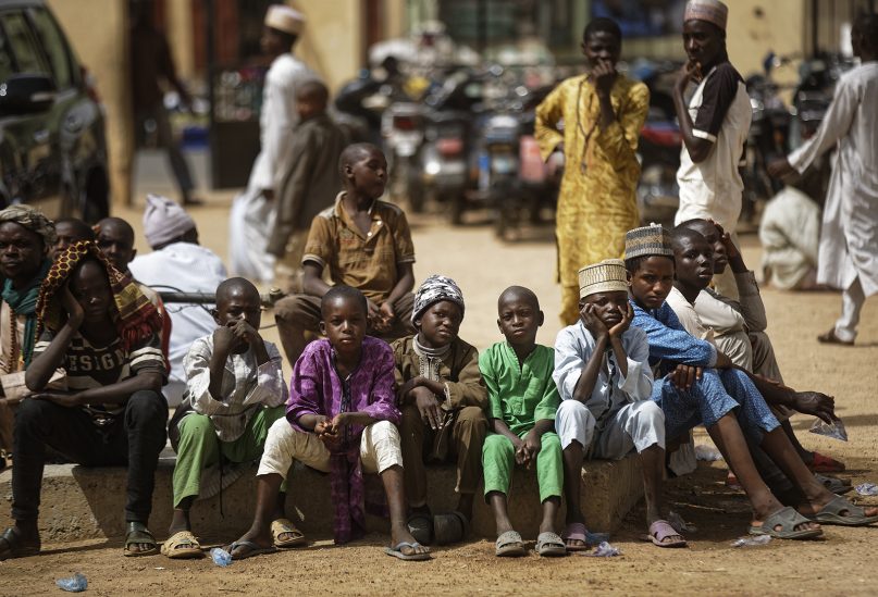 Young Muslim boys wait for traditional Friday prayers to begin at a mosque near the Emir's palace a day prior to the start of the elections, in Kano, northern Nigeria, on Feb. 15, 2019. (AP Photo/Ben Curtis)