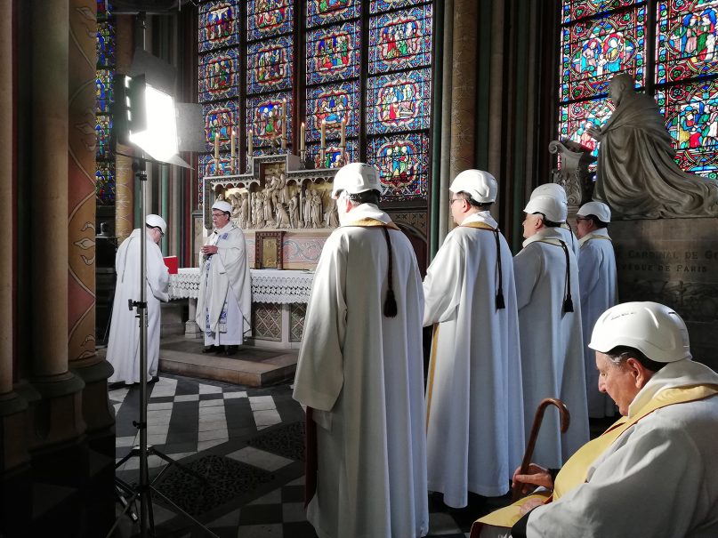 The Archbishop of Paris, Michel Aupetit, second left, leads the first mass in a side chapel, two months after a devastating fire engulfed the Notre Dame Cathedral on June 15, 2019, in Paris. (Karine Perret, Pool via AP)