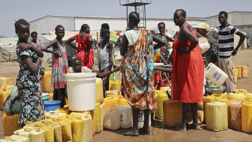 Residents of the Mangateen camp for the internally displaced line up to get water from a borehole, on the outskirts of the capital Juba, South Sudan, on Jan. 22, 2019. Tens of thousands of people are still sheltering in United Nations protected camps across the country, the legacy of an unprecedented decision by a U.N. peacekeeping mission to throw open its doors to people fleeing war. (AP Photo/Sam Mednick)